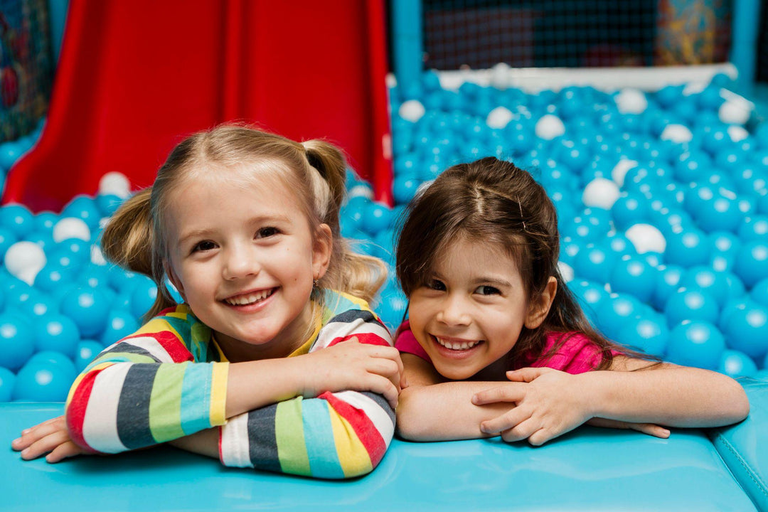 Happy kids in a daycare ball pit, probiotics benefits